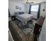 Bright bedroom featuring a comfortable bed, stylish rug, and ample natural light from a window at 6318 Ridge Crest Dr, Port Richey, FL 34668