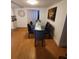 Dining room with hardwood floors, a glass dining table with six chairs, and art on the wall at 6318 Ridge Crest Dr, Port Richey, FL 34668