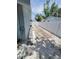 Long driveway with white shell landscaping and a white fence at 6318 Ridge Crest Dr, Port Richey, FL 34668