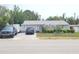 Exterior of a light blue single-story home with a well-manicured front yard and a two car garage at 6318 Ridge Crest Dr, Port Richey, FL 34668