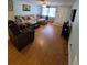 Inviting living room featuring hardwood floors, a comfortable seating area, and plenty of natural light at 6318 Ridge Crest Dr, Port Richey, FL 34668