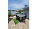 Paver patio featuring bar seating, a swing, and manicured landscaping for relaxation and entertaining at 6318 Ridge Crest Dr, Port Richey, FL 34668
