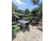 Paver patio complete with a bar-height table, outdoor seating, and lush landscaping perfect for outdoor living at 6318 Ridge Crest Dr, Port Richey, FL 34668