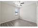 Bright bedroom with modern ceiling fan, wood-look flooring, and window at 6670 Paden Wheel St, Zephyrhills, FL 33541