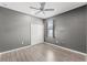 Light bedroom with a ceiling fan, a window, and a closet at 6670 Paden Wheel St, Zephyrhills, FL 33541
