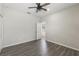 Well-lit bedroom boasts a stylish ceiling fan, convenient closet, and wood-look flooring at 6670 Paden Wheel St, Zephyrhills, FL 33541