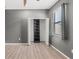 Bedroom with wood-look flooring, window and a closet with organizers at 6670 Paden Wheel St, Zephyrhills, FL 33541
