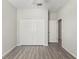 Spacious bedroom with wood-look flooring, closet and ceiling fan at 6670 Paden Wheel St, Zephyrhills, FL 33541