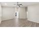 Spacious bedroom with hardwood floors and a ceiling fan, offering ample space and comfort at 6670 Paden Wheel St, Zephyrhills, FL 33541