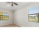 Bright bedroom featuring two windows and a ceiling fan, creating a comfortable and airy atmosphere at 6670 Paden Wheel St, Zephyrhills, FL 33541
