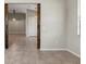Open entryway with rustic wood columns, ceramic tile flooring, and a glimpse into adjacent rooms at 6670 Paden Wheel St, Zephyrhills, FL 33541