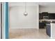 Bright kitchen featuring dark cabinetry and stainless steel appliances at 6670 Paden Wheel St, Zephyrhills, FL 33541