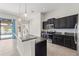Kitchen view showcasing a center island and dark cabinets with stainless steel appliances and view of the pool area at 6670 Paden Wheel St, Zephyrhills, FL 33541