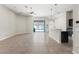 Open living space with kitchen featuring dark cabinets and view of the pool at 6670 Paden Wheel St, Zephyrhills, FL 33541