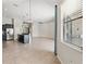 Open living space with kitchen island and view of the dining room at 6670 Paden Wheel St, Zephyrhills, FL 33541