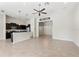 Open living space featuring a kitchen with dark cabinets and a dining room at 6670 Paden Wheel St, Zephyrhills, FL 33541