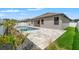 A backyard pool with stone pavers and small green tropical landscaping at 6670 Paden Wheel St, Zephyrhills, FL 33541