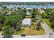 Aerial view of a lovely home surrounded by mature trees and landscaping, set back from the street at 695 Sunset Dr, Tarpon Springs, FL 34689