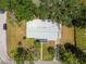 Bird's eye view of a home with a large roof and well-maintained lawn in a quiet residential area at 695 Sunset Dr, Tarpon Springs, FL 34689