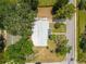 Overhead view of a home with mature trees, green lawns, and street access on a sunny day at 695 Sunset Dr, Tarpon Springs, FL 34689