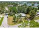 Charming home surrounded by lush landscaping with a view of mature trees providing a serene setting at 695 Sunset Dr, Tarpon Springs, FL 34689