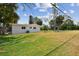 Expansive backyard with lush green grass and mature trees, perfect for outdoor activities at 695 Sunset Dr, Tarpon Springs, FL 34689