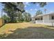 Lush backyard with a covered patio area, ideal for relaxing and entertaining at 695 Sunset Dr, Tarpon Springs, FL 34689
