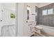 Bathroom features gray tile in the bath, and a white vanity with black fixtures at 695 Sunset Dr, Tarpon Springs, FL 34689