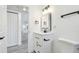 Bathroom features gray tile in the bath, and a white vanity with black fixtures at 695 Sunset Dr, Tarpon Springs, FL 34689
