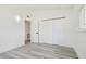 Bright bedroom features a closet, and gray wood-look flooring, with white walls at 695 Sunset Dr, Tarpon Springs, FL 34689