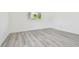 Clean, white bedroom with fresh paint and attractive light gray flooring at 695 Sunset Dr, Tarpon Springs, FL 34689