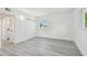 Clean bedroom featuring a closet, fresh paint, and attractive light gray flooring at 695 Sunset Dr, Tarpon Springs, FL 34689
