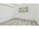 Bright bedroom features a closet, window, and gray wood-look flooring, with white walls at 695 Sunset Dr, Tarpon Springs, FL 34689