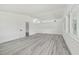 Spacious bedroom with natural light from large windows and new grey flooring throughout at 695 Sunset Dr, Tarpon Springs, FL 34689
