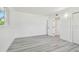 A light and airy bedroom with fresh paint and light gray flooring throughout at 695 Sunset Dr, Tarpon Springs, FL 34689