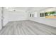 Bright bedroom featuring large windows, grey flooring and freshly painted, white walls at 695 Sunset Dr, Tarpon Springs, FL 34689