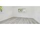 Bright bedroom with fresh paint, white trim, and light gray wood-look floors at 695 Sunset Dr, Tarpon Springs, FL 34689