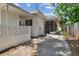 Exterior view of the home, featuring a screened patio and lush landscaping at 695 Sunset Dr, Tarpon Springs, FL 34689