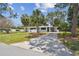 Charming single-story home featuring a well-manicured lawn and a concrete driveway at 695 Sunset Dr, Tarpon Springs, FL 34689