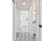 Hallway features neutral paint, wood look floors, and white doors at 695 Sunset Dr, Tarpon Springs, FL 34689