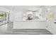 Beautiful open kitchen with white cabinets, stainless steel appliances, and an island at 695 Sunset Dr, Tarpon Springs, FL 34689