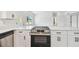 Modern kitchen featuring white cabinets, stainless steel appliances and quartz countertops at 695 Sunset Dr, Tarpon Springs, FL 34689