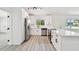 Bright kitchen with white cabinets, stainless steel appliances, and modern track lighting at 695 Sunset Dr, Tarpon Springs, FL 34689