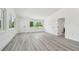 Bright room featuring fresh grey flooring, recently painted walls and windows with a neighborhood view at 695 Sunset Dr, Tarpon Springs, FL 34689