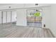 Bright room with new sliding glass doors to the outdoor patio space and grey wood-look flooring at 695 Sunset Dr, Tarpon Springs, FL 34689