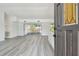 Open living room featuring light gray flooring and sliding glass doors to the outside at 695 Sunset Dr, Tarpon Springs, FL 34689