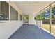 Spacious covered patio with gray flooring provides an outdoor living space at 695 Sunset Dr, Tarpon Springs, FL 34689