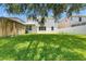 Expansive backyard with lush lawn, shed, and white fence for privacy at 7013 Early Gold Ln, Riverview, FL 33578