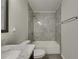 Well-lit bathroom with a tub and modern gray tiling at 7013 Early Gold Ln, Riverview, FL 33578