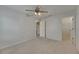 Carpeted bedroom with a ceiling fan, closet, and ensuite bathroom at 7013 Early Gold Ln, Riverview, FL 33578
